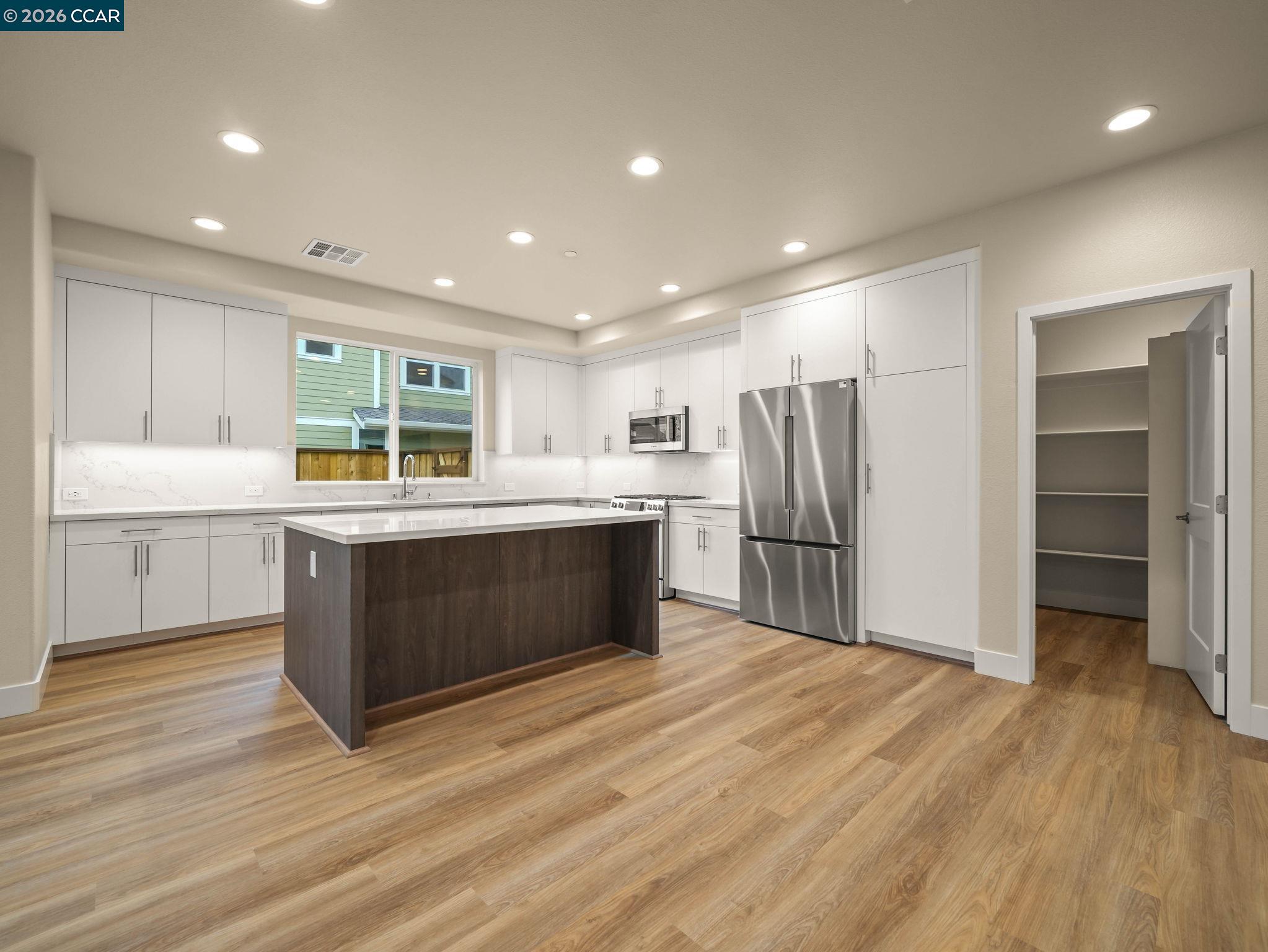3030 Byron Road Tracy, CA 95377 - Photo 7 of 58 a kitchen with stainless steel appliances kitchen island granite countertop a refrigerator and a sink