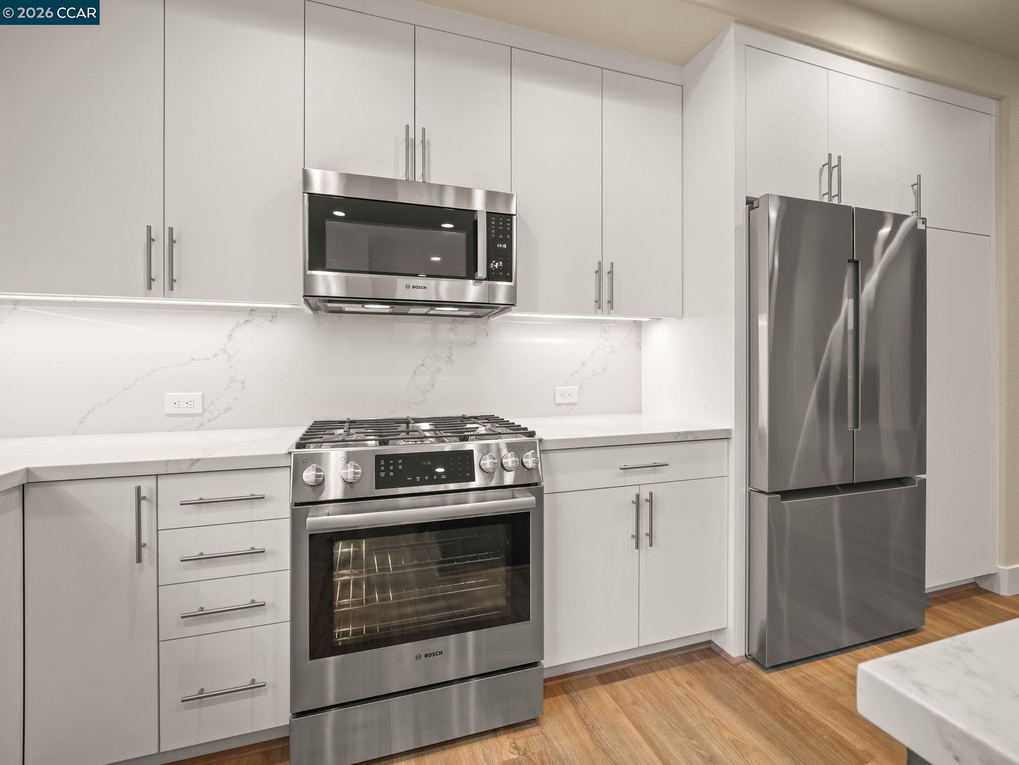 3030 Byron Road Tracy, CA 95377 - Photo 9 of 58 a kitchen with white cabinets and stainless steel appliances