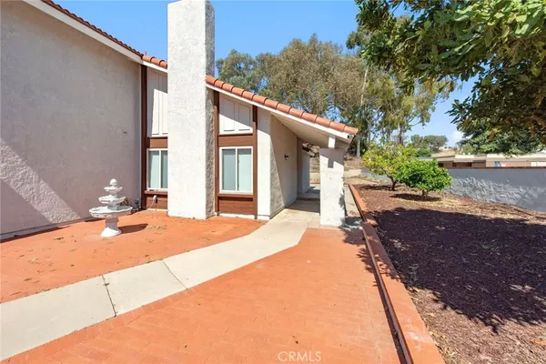 a backyard of a house with table and chairs