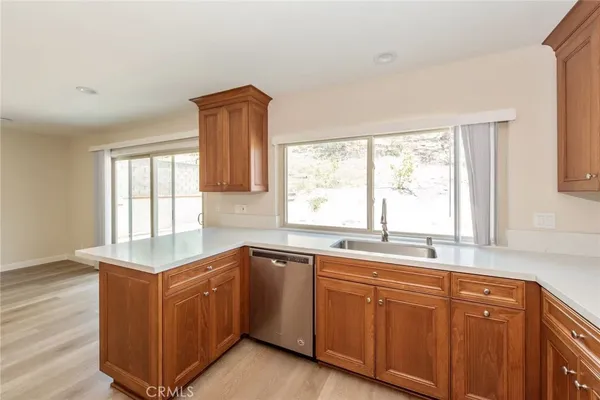 a kitchen with sink cabinets and window