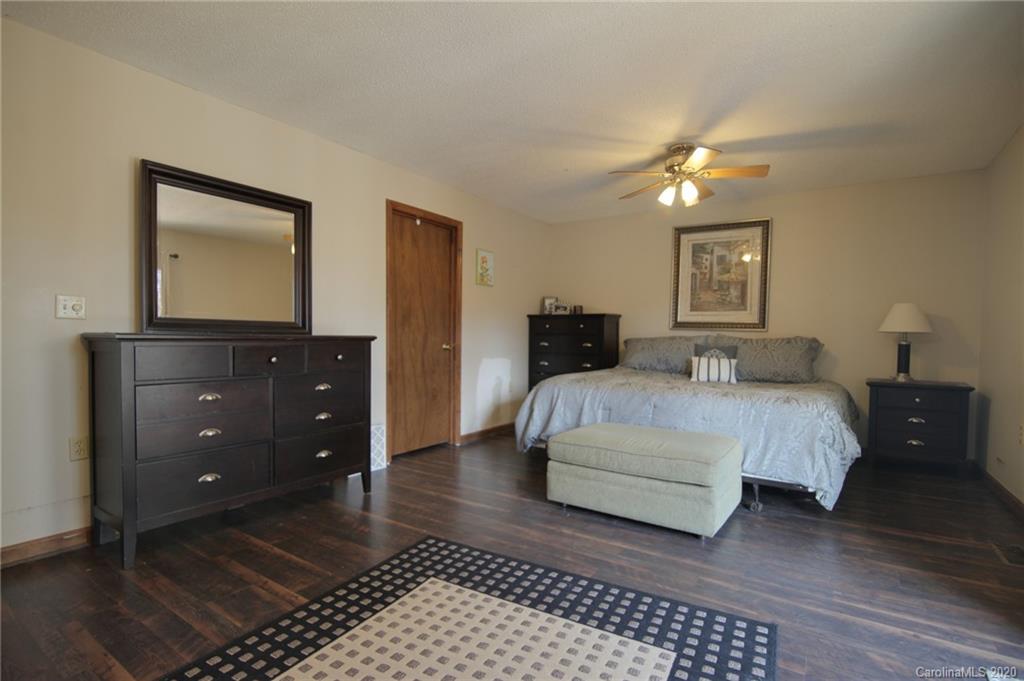 268 Painter Road Mill Spring, NC 28756 - Photo 15 of 41 a bedroom with a bed and a dresser