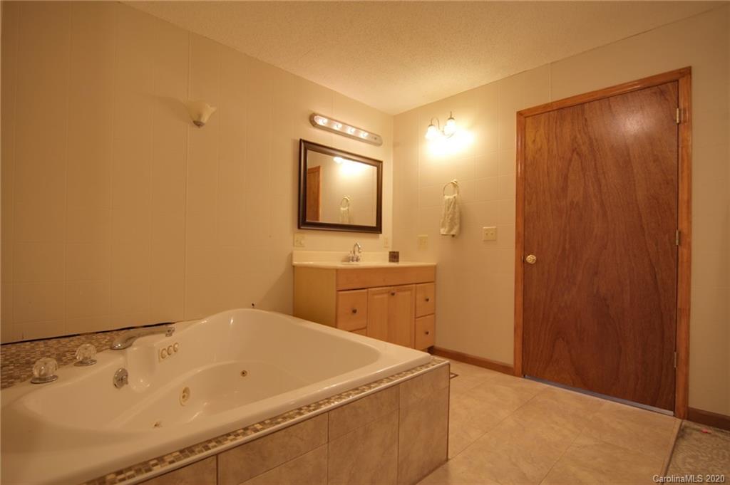 268 Painter Road Mill Spring, NC 28756 - Photo 17 of 41 a bathroom with a sink and a mirror