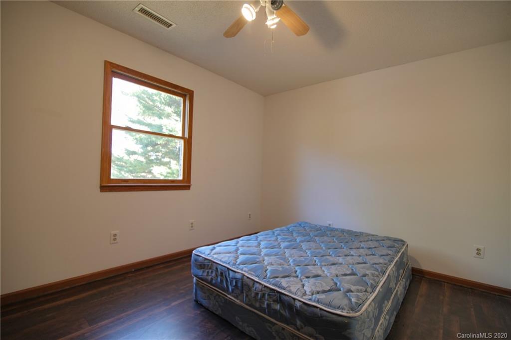 268 Painter Road Mill Spring, NC 28756 - Photo 21 of 41 an empty room with wooden floor and windows