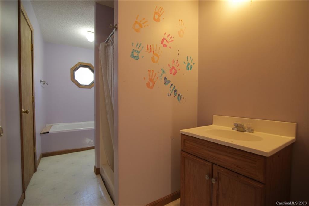 268 Painter Road Mill Spring, NC 28756 - Photo 22 of 41 a bathroom with a sink and a mirror