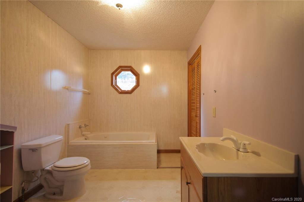 268 Painter Road Mill Spring, NC 28756 - Photo 23 of 41 a bathroom with a sink a toilet and shower