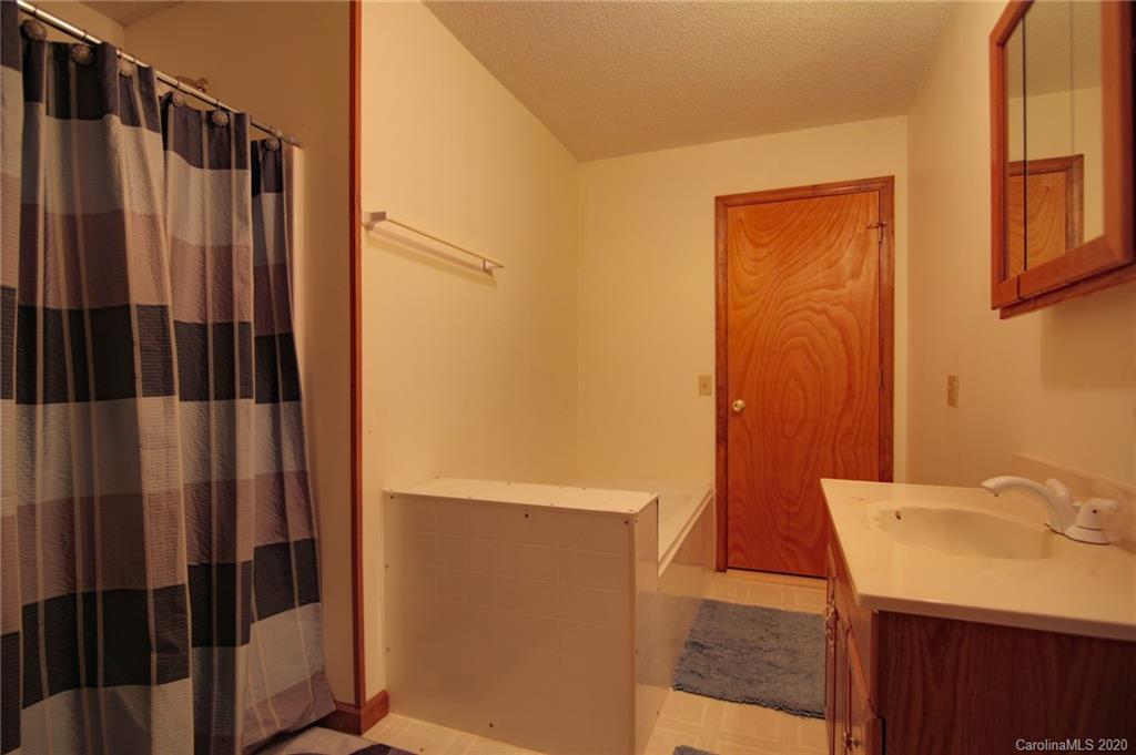 268 Painter Road Mill Spring, NC 28756 - Photo 25 of 41 a bathroom with a sink and a mirror
