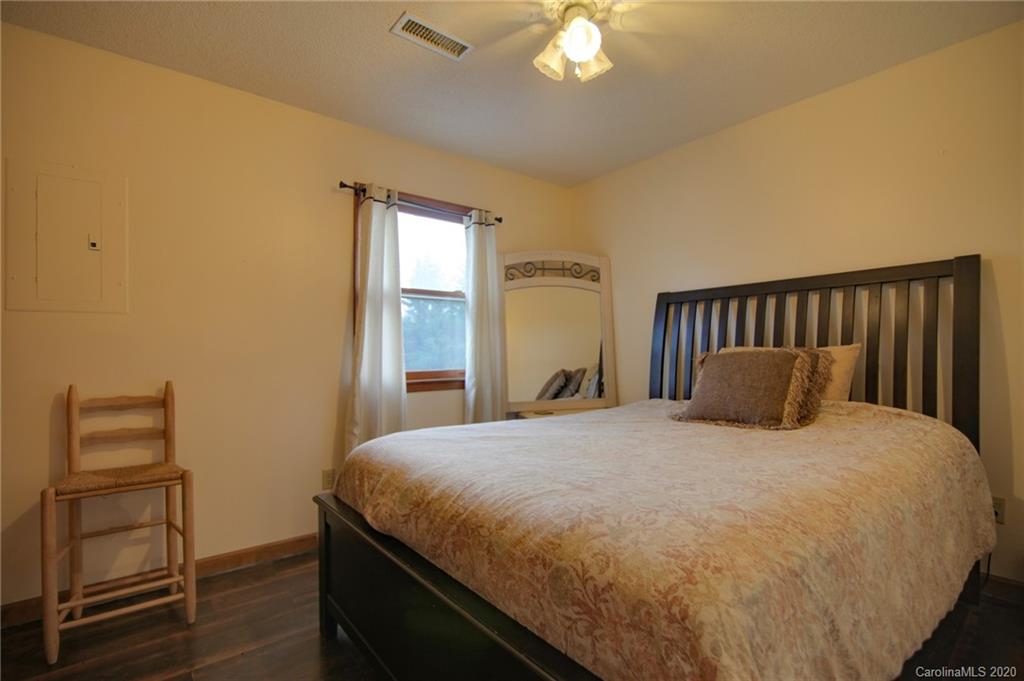 268 Painter Road Mill Spring, NC 28756 - Photo 26 of 41 a large bed in a bedroom next to a window