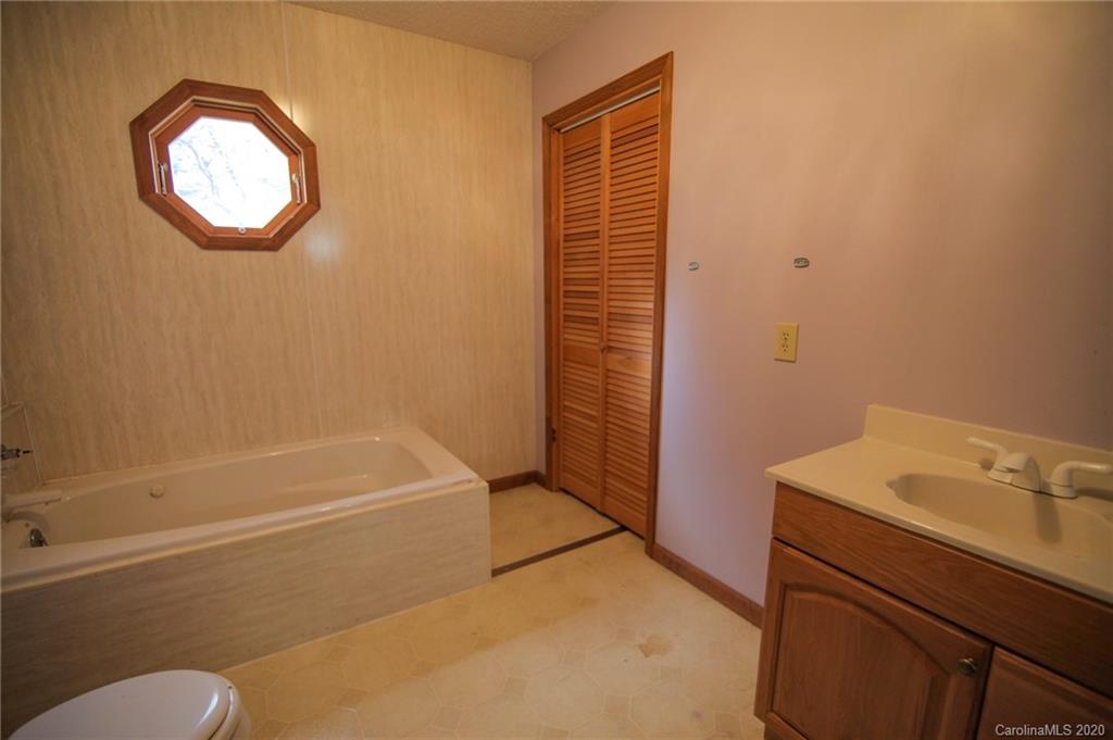 268 Painter Road Mill Spring, NC 28756 - Photo 28 of 41 a bathroom with a bathtub and a sink