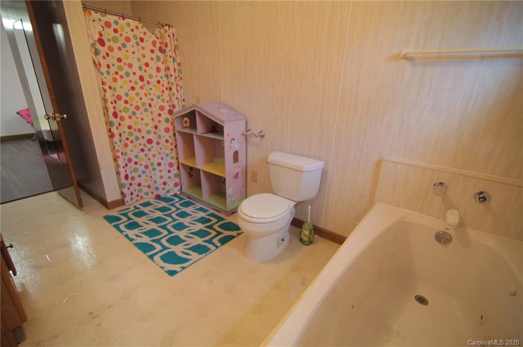268 Painter Road Mill Spring, NC 28756 - Photo 29 of 41 a bathroom with a sink toilet and shower