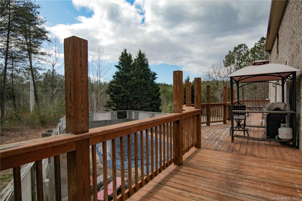 268 Painter Road Mill Spring, NC 28756 - Photo 30 of 41 a view of a balcony with chairs and wooden floor