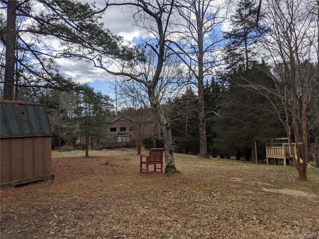 268 Painter Road Mill Spring, NC 28756 - Photo 34 of 41 a backyard of a house with a tree