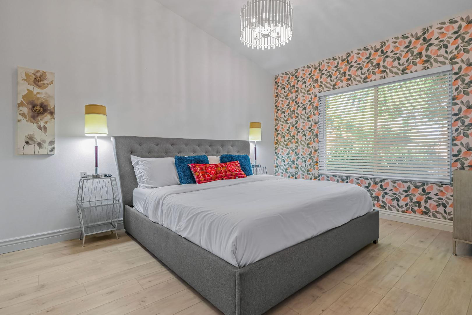 5449 East Phelps Road Scottsdale, AZ 85254 - Photo 19 of 28 a large bed sitting in a bedroom next to a window and a chandelier