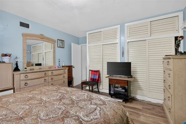 a room with a bed and a flat screen tv