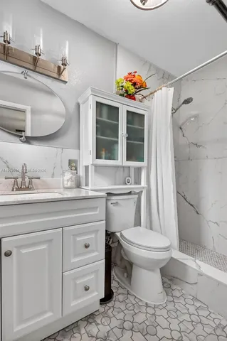 a bathroom with a sink toilet and shower