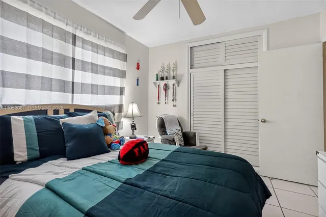 a bedroom with a bed and a chair