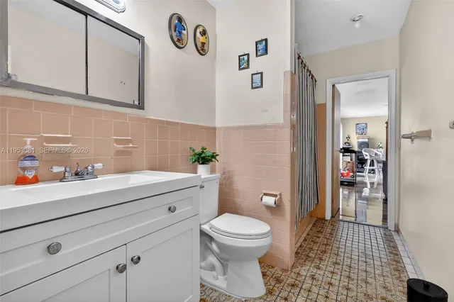 a bathroom with a sink a toilet and a shower