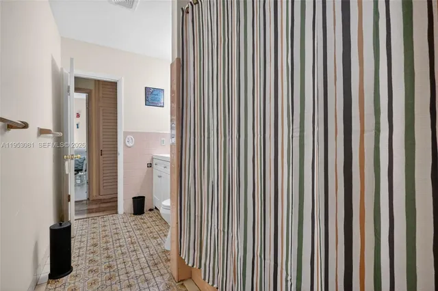 a bathroom with a glass door shower