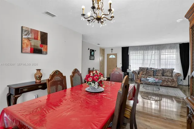 a dining room with furniture and chandelier