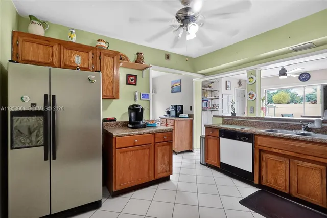 a kitchen with stainless steel appliances granite countertop a refrigerator a sink and dishwasher