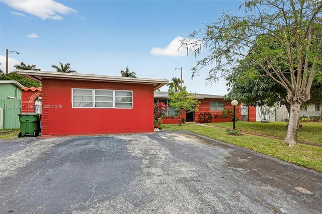 a view of a house with a yard and tree s