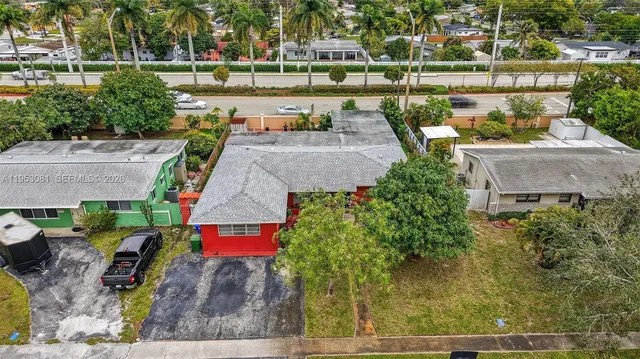 an aerial view of a house with a yard basket ball court and outdoor seating