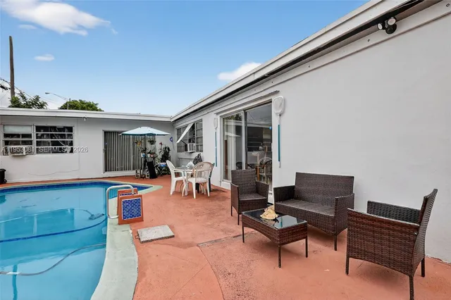 a outdoor living space with furniture and a flat screen tv