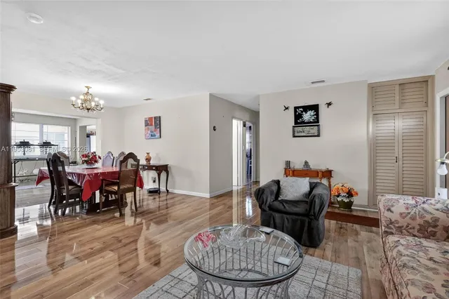 a living room with furniture chess table and a window