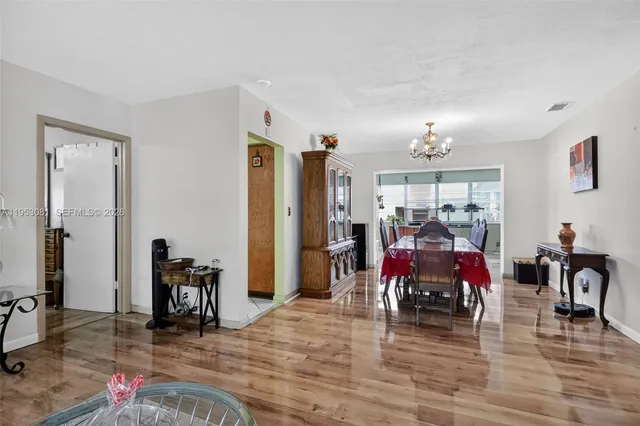 a view of a dining room with furniture and chandelier