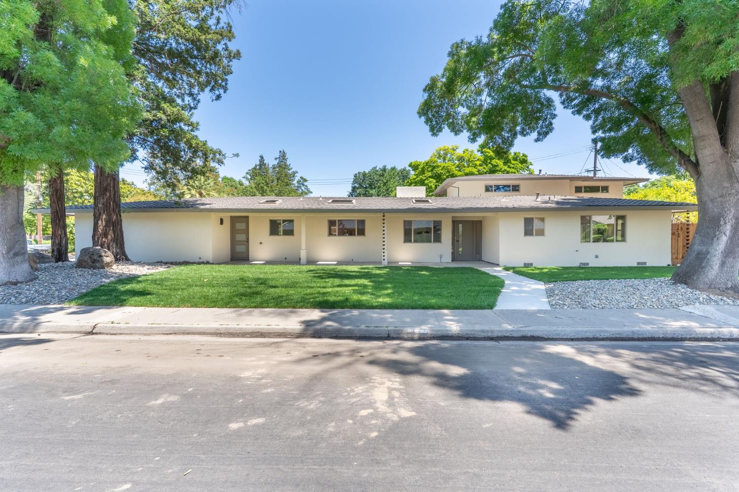 a front view of house with yard and green space