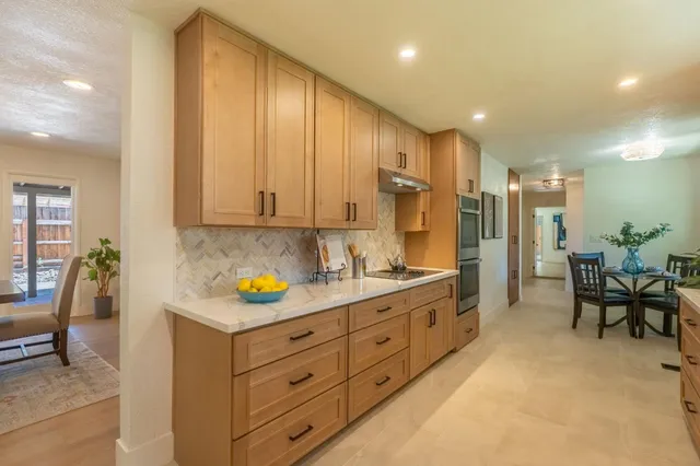 a spacious bathroom with a granite countertop sink and a mirror