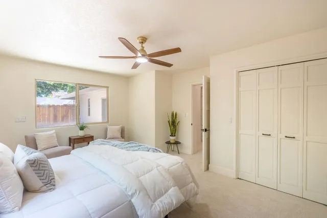 a bedroom with a bed and a potted plant