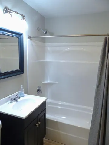 a bathroom with a sink a mirror and a bathtub