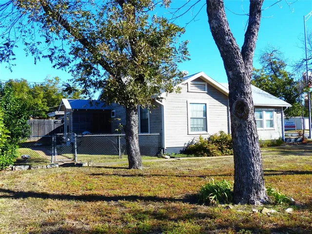 a view of a house with backyard porch and sitting area