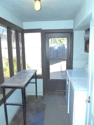 a view of a room with a table and chairs