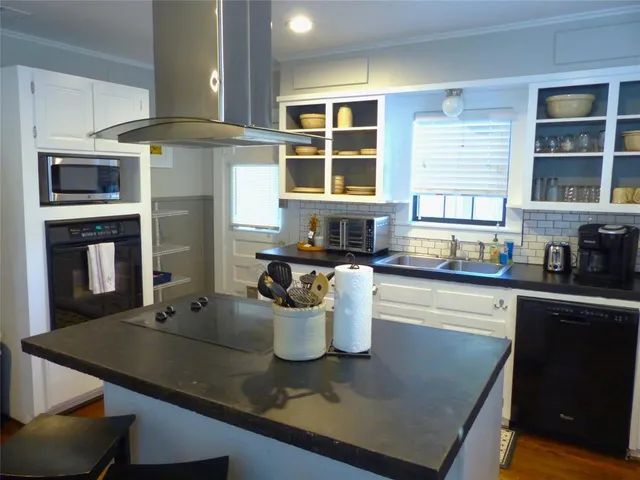 a kitchen with a stove a sink and a microwave