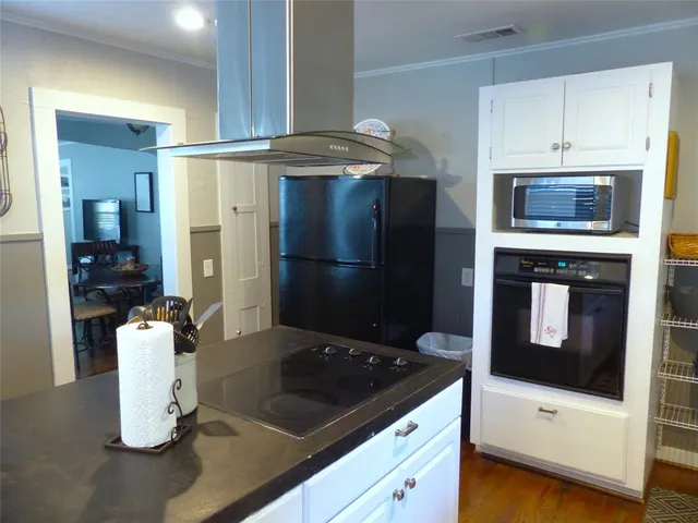 a kitchen with stainless steel appliances granite countertop a refrigerator and a stove top oven