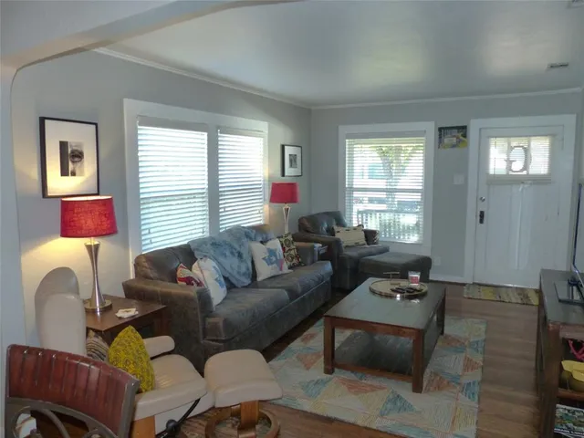 a living room with furniture a window and a lamp