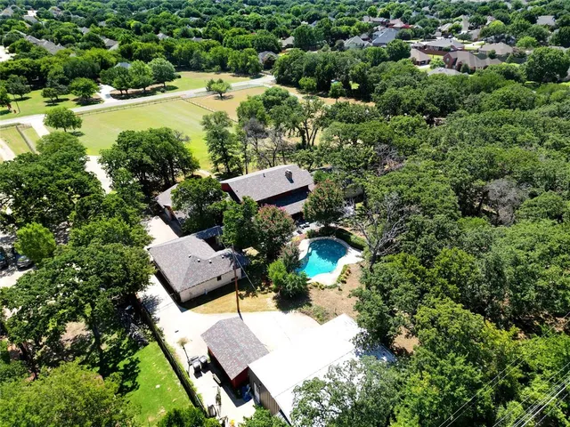 aerial view of a house with yard and outdoor seating