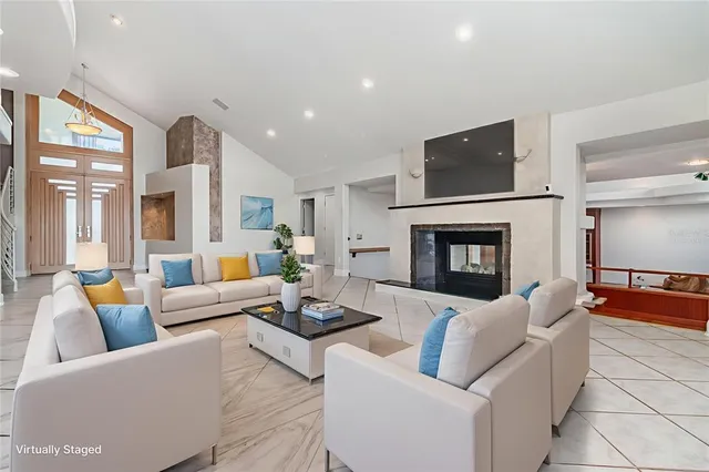 a living room with blue lights with furniture