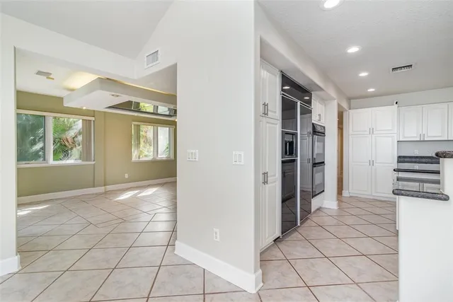 a spacious bedroom with a bed painting on wall and a fireplace