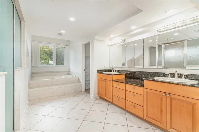 a bathroom with a granite countertop sink a toilet and a mirror