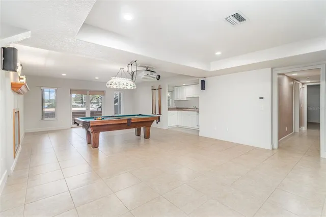 a view of a porch with furniture and floor to ceiling windows
