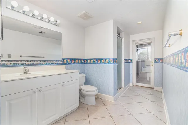 a view of a porch with furniture and floor to ceiling windows