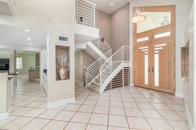 a living room with fireplace furniture and a floor to ceiling window
