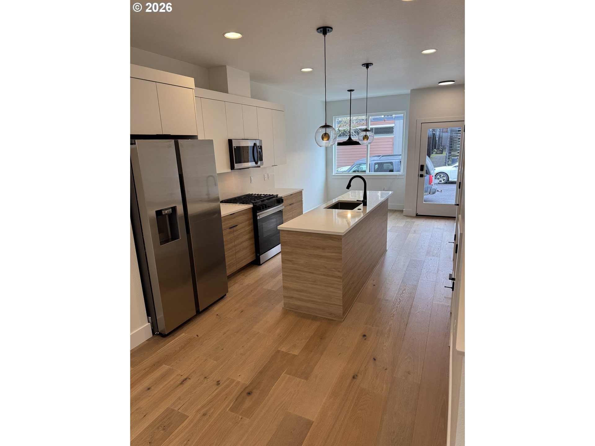 2383 Southeast 43rd Avenue Portland, OR 97206 - Photo 5 of 24 a kitchen with refrigerator and chairs