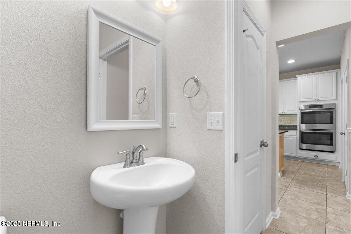 1011 Wetland Ridge Circle Middleburg, FL 32068 - Photo 12 of 73 a bathroom with a sink and a mirror