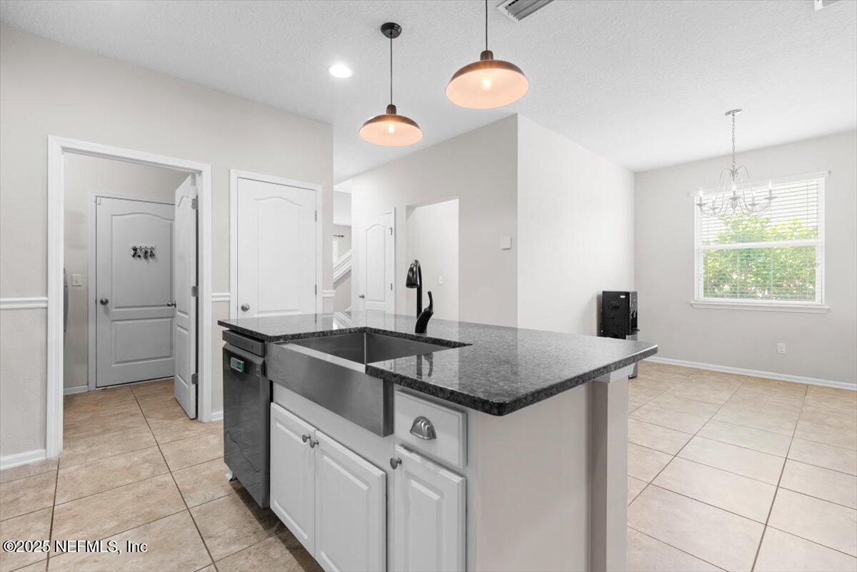 1011 Wetland Ridge Circle Middleburg, FL 32068 - Photo 15 of 73 a kitchen with stainless steel appliances granite countertop a sink a stove and a window
