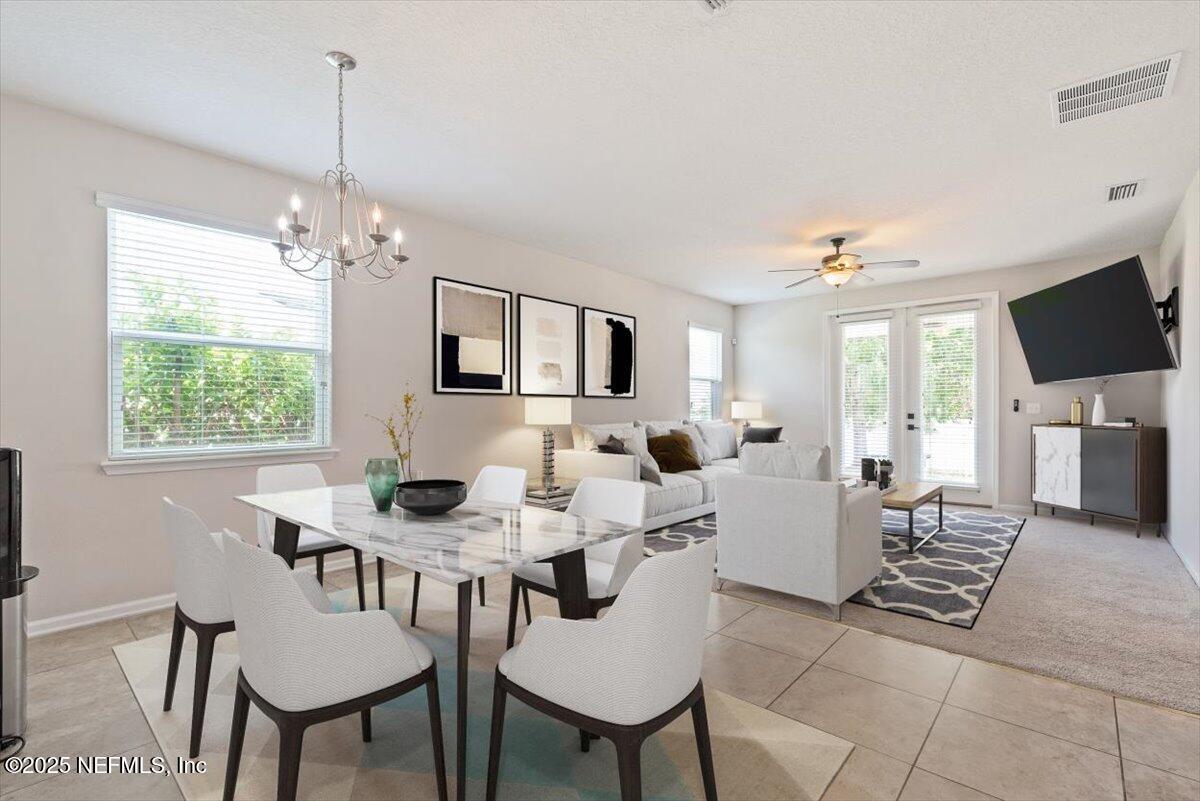 1011 Wetland Ridge Circle Middleburg, FL 32068 - Photo 18 of 73 a view of a livingroom and dining room with furniture wooden floor a chandelier
