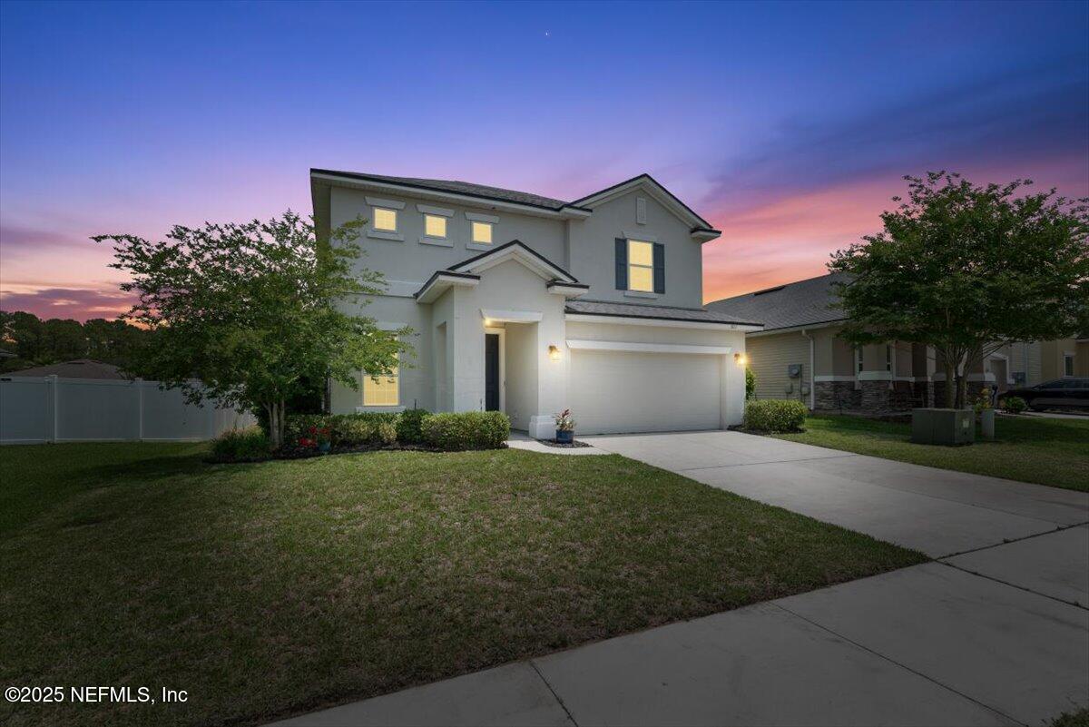 1011 Wetland Ridge Circle Middleburg, FL 32068 - Photo 2 of 73 a front view of a house with a yard and garage