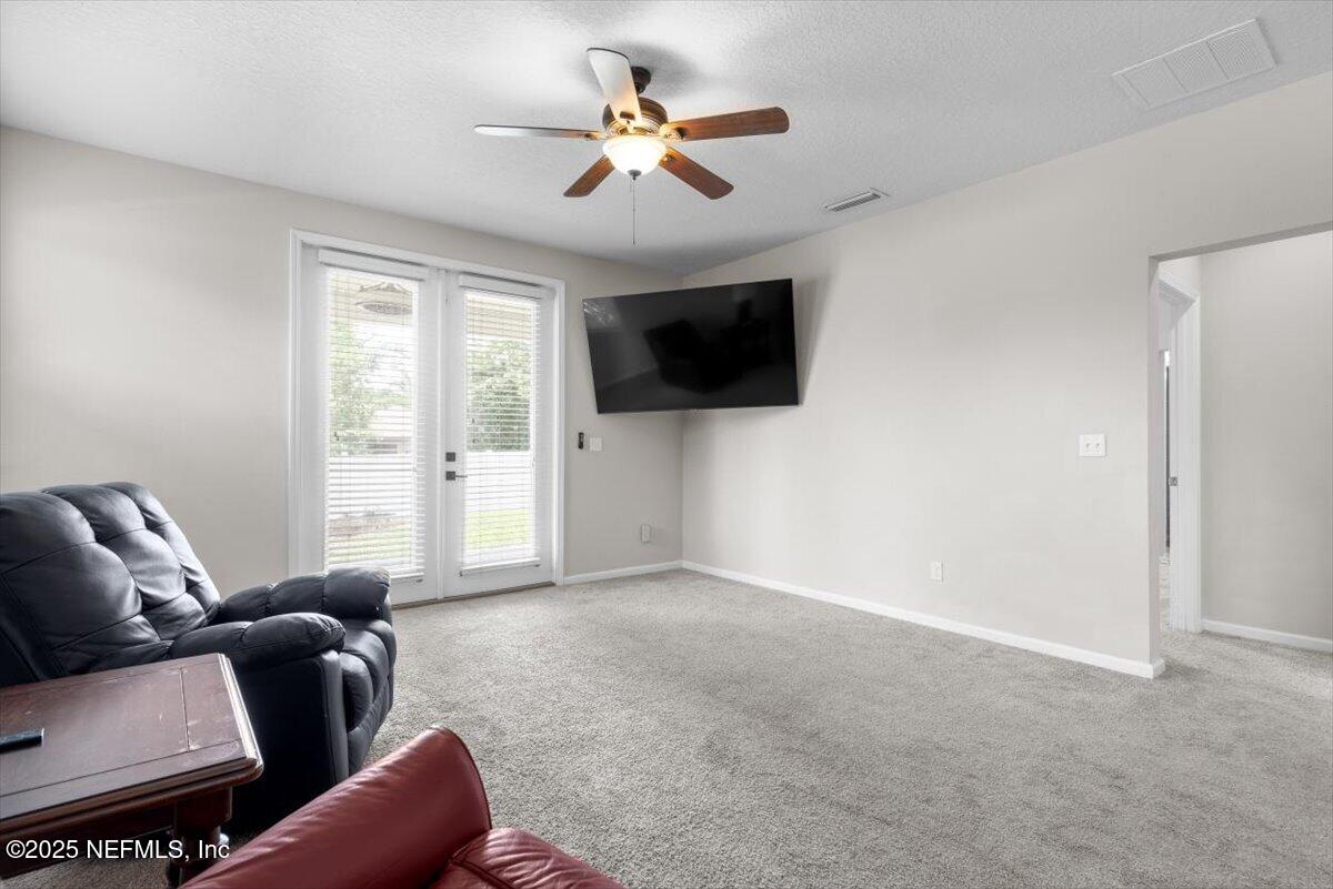 1011 Wetland Ridge Circle Middleburg, FL 32068 - Photo 22 of 73 a living room with furniture and a flat screen tv